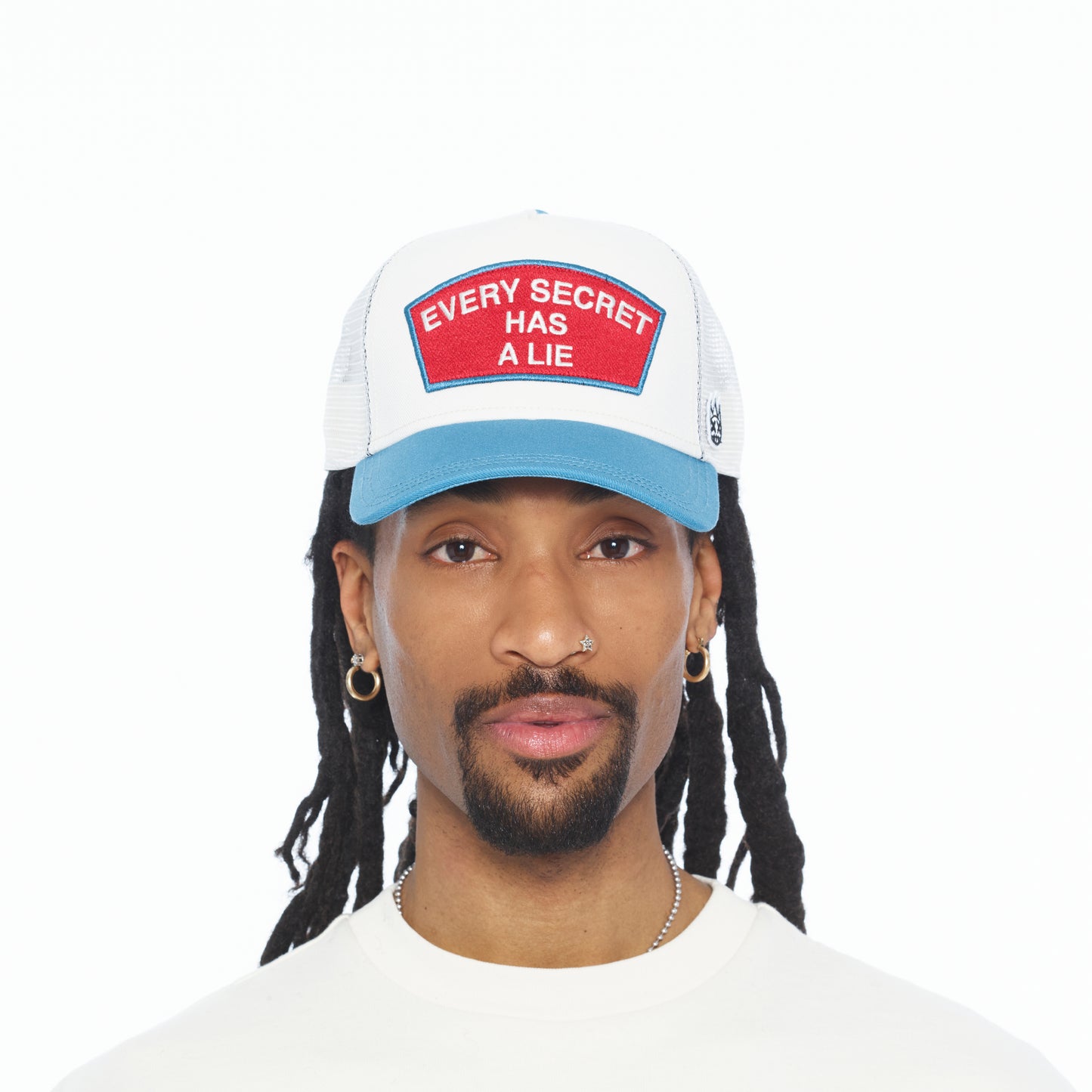 Cult's Mesh Back Trucker Hat "Every Secret Has A Lie" In Winter White