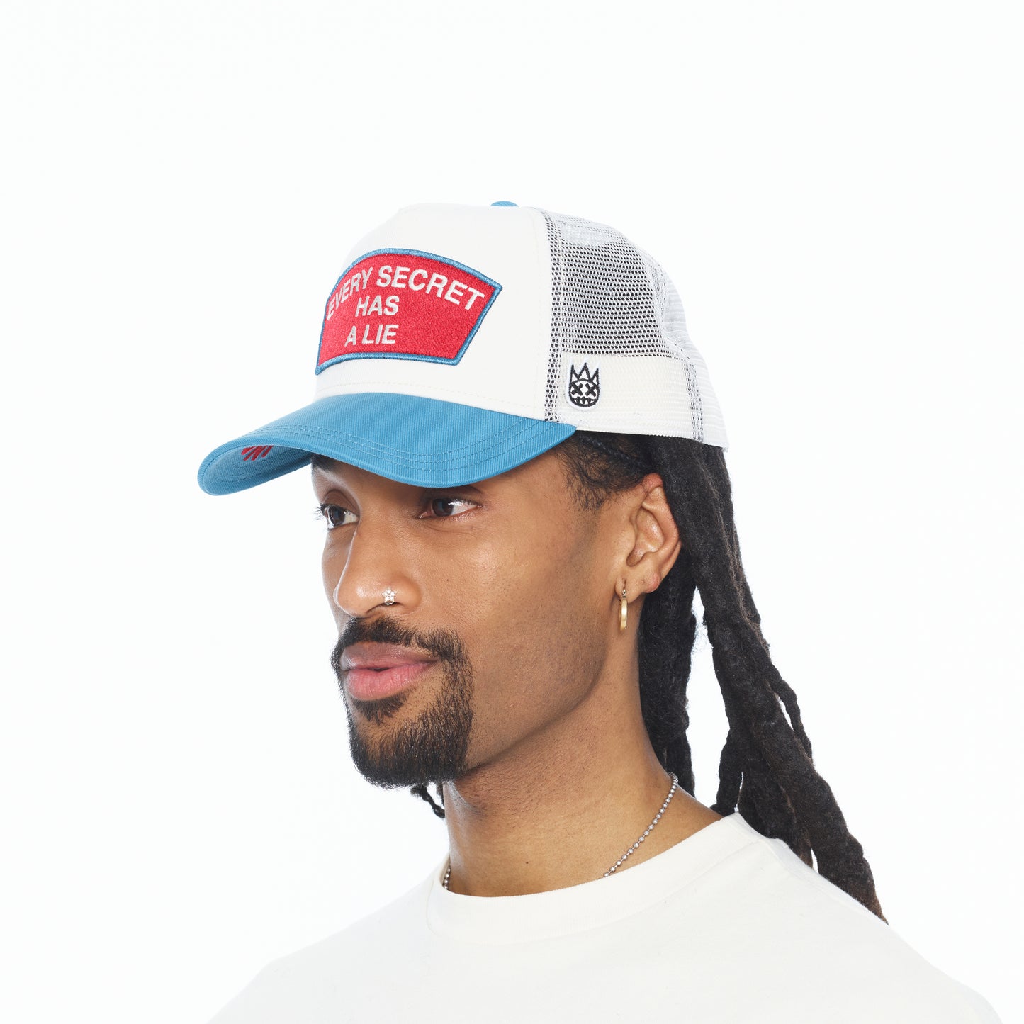 Cult's Mesh Back Trucker Hat "Every Secret Has A Lie" In Winter White